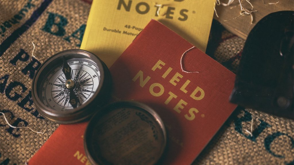 a compass with field notes booklets